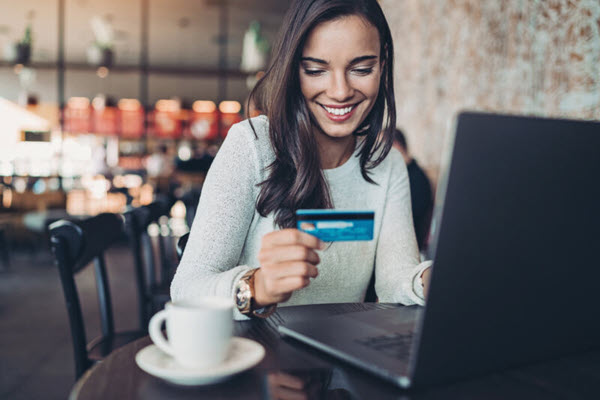 Woman online shopping with a credit card.
