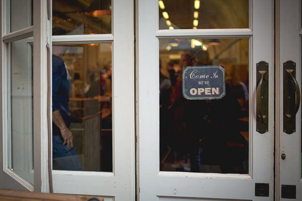 A storefront with an open sign on the door