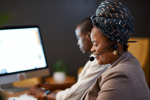 Contact center agent talking on a headset