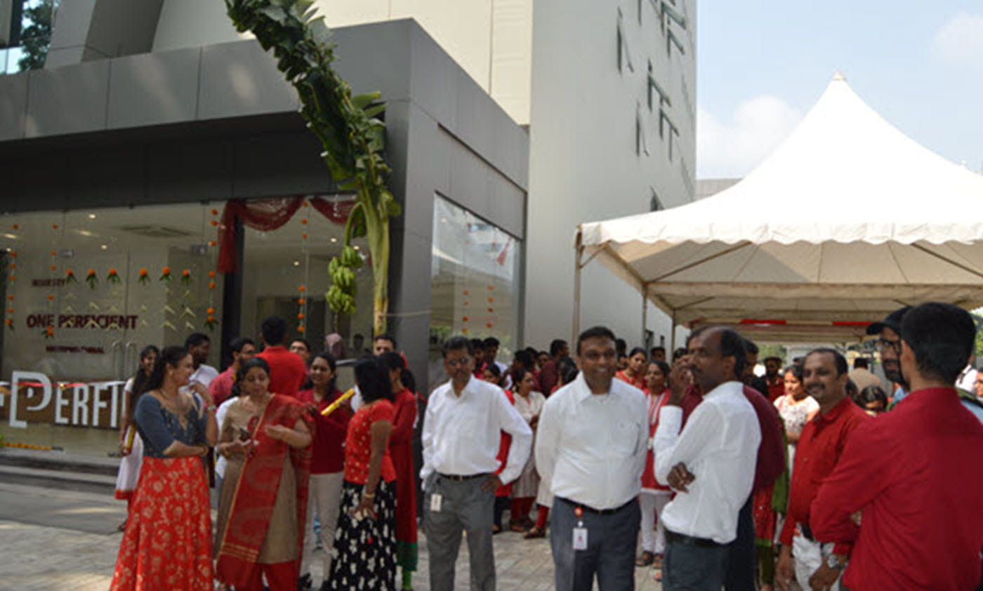 A dozen or so Perficient colleagues outside of a Perficient office in India