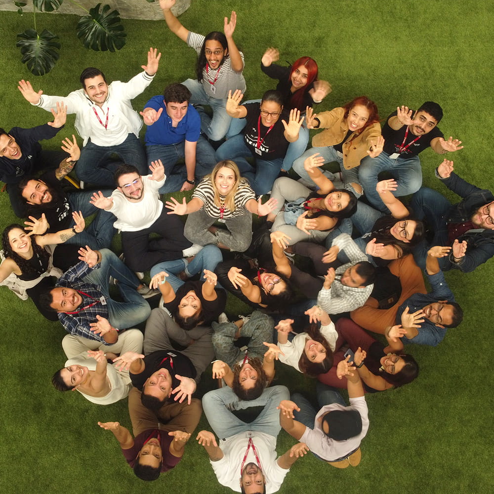 A group of people looking up with their hands raised to the sky.  