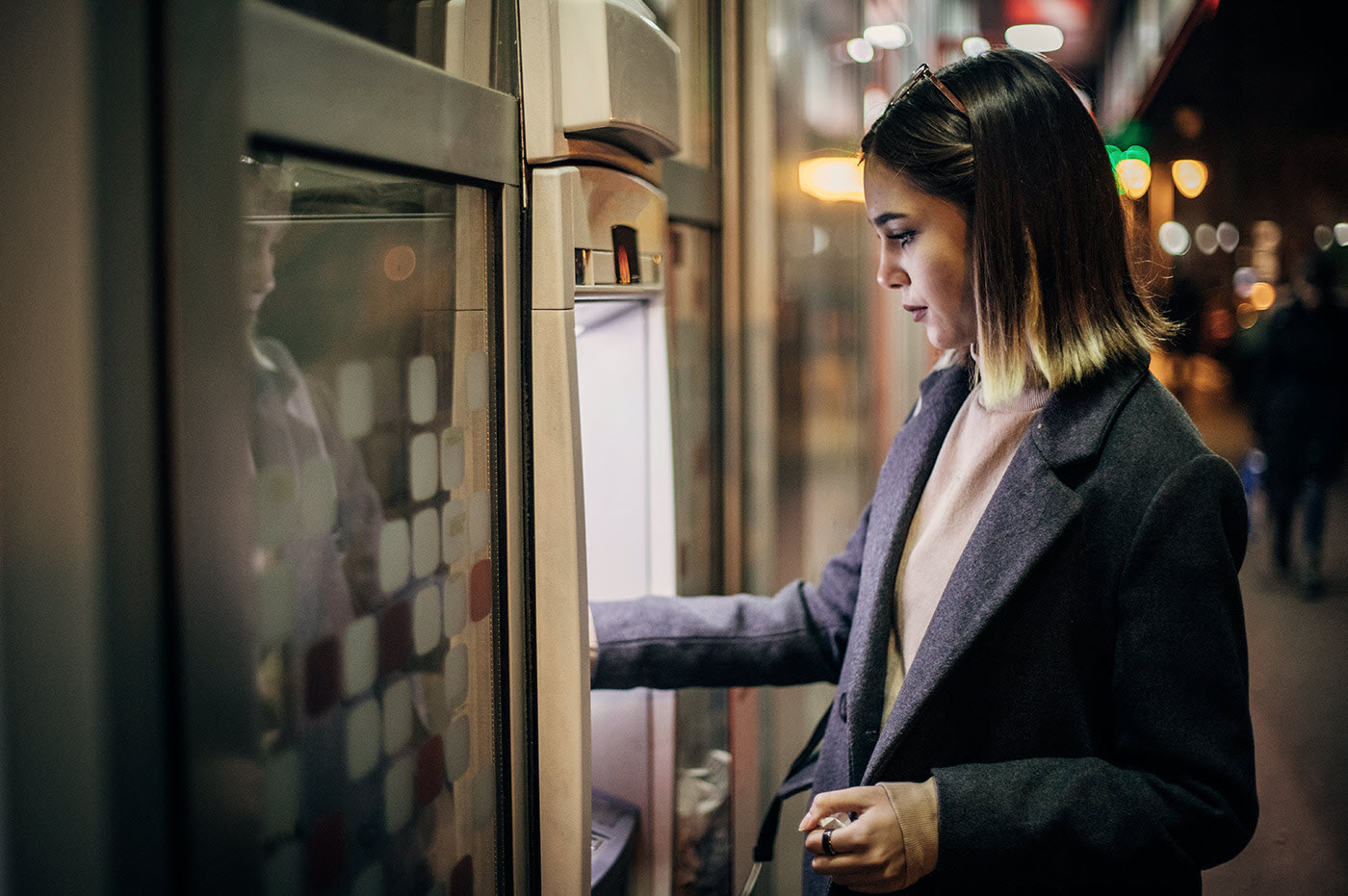 A woman using an ATM machine. 