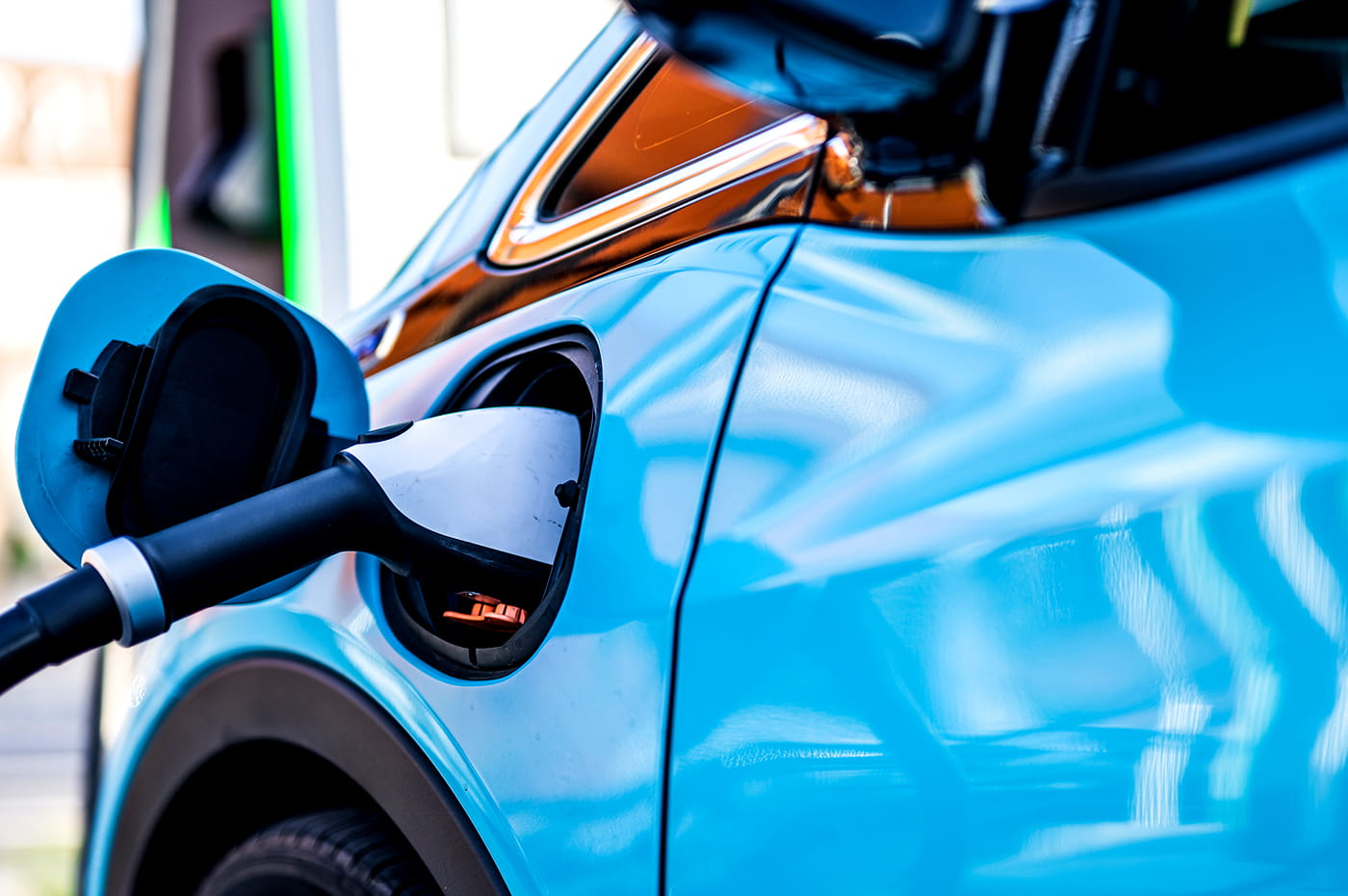 An electric vehicle (EV) plugged in to charge.