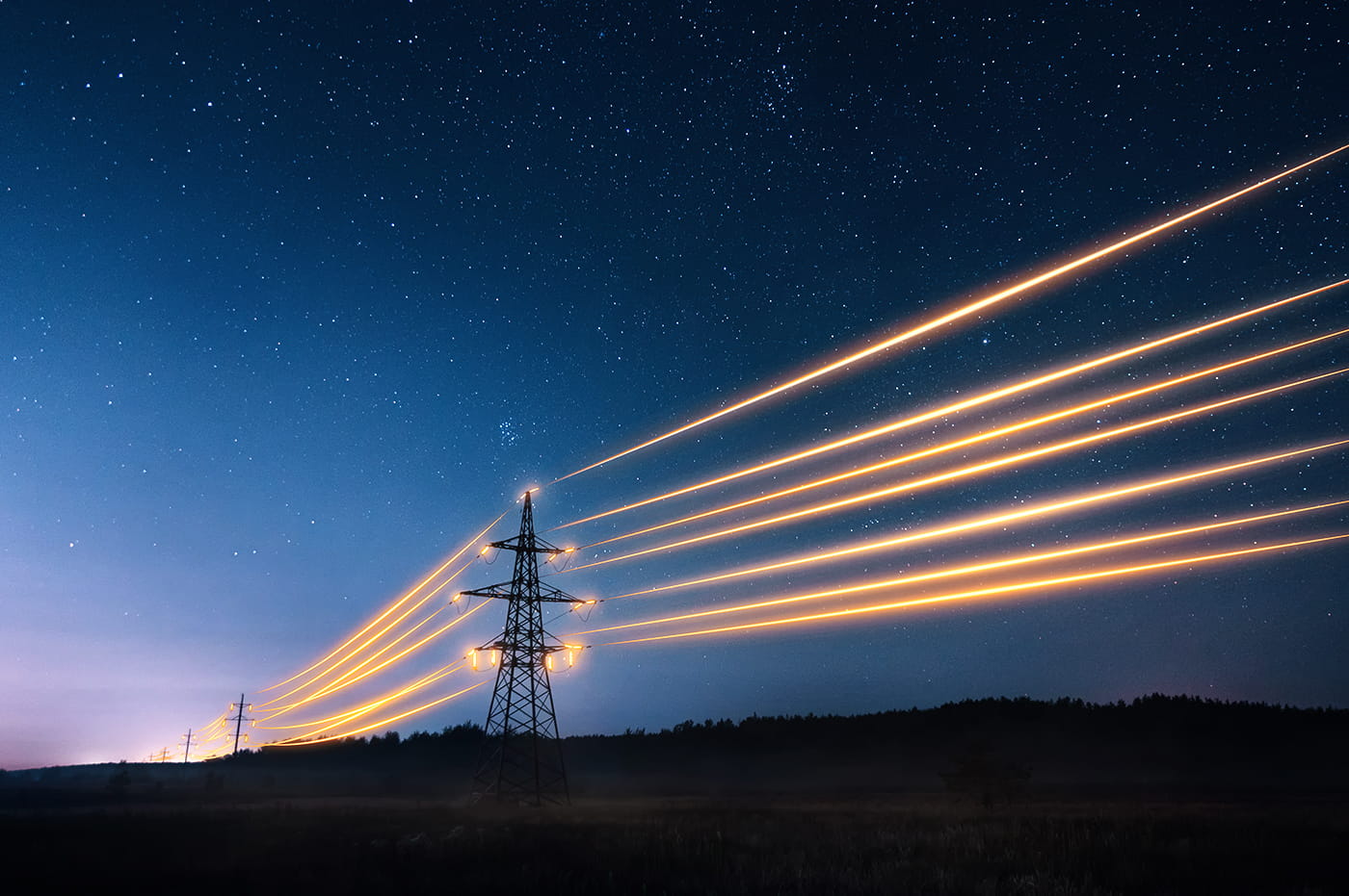 Glowing energy towers at night.