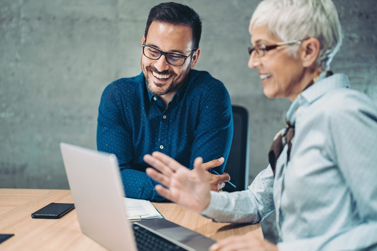 Senior Business woman talking to young colleague