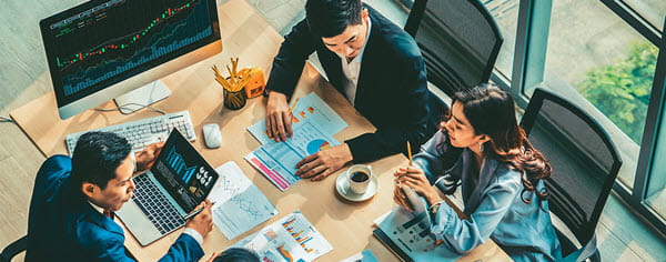 Overhead shot of 3 people meeting at work during the day