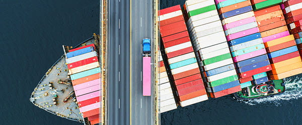 Supply Chain ship passing under a highway