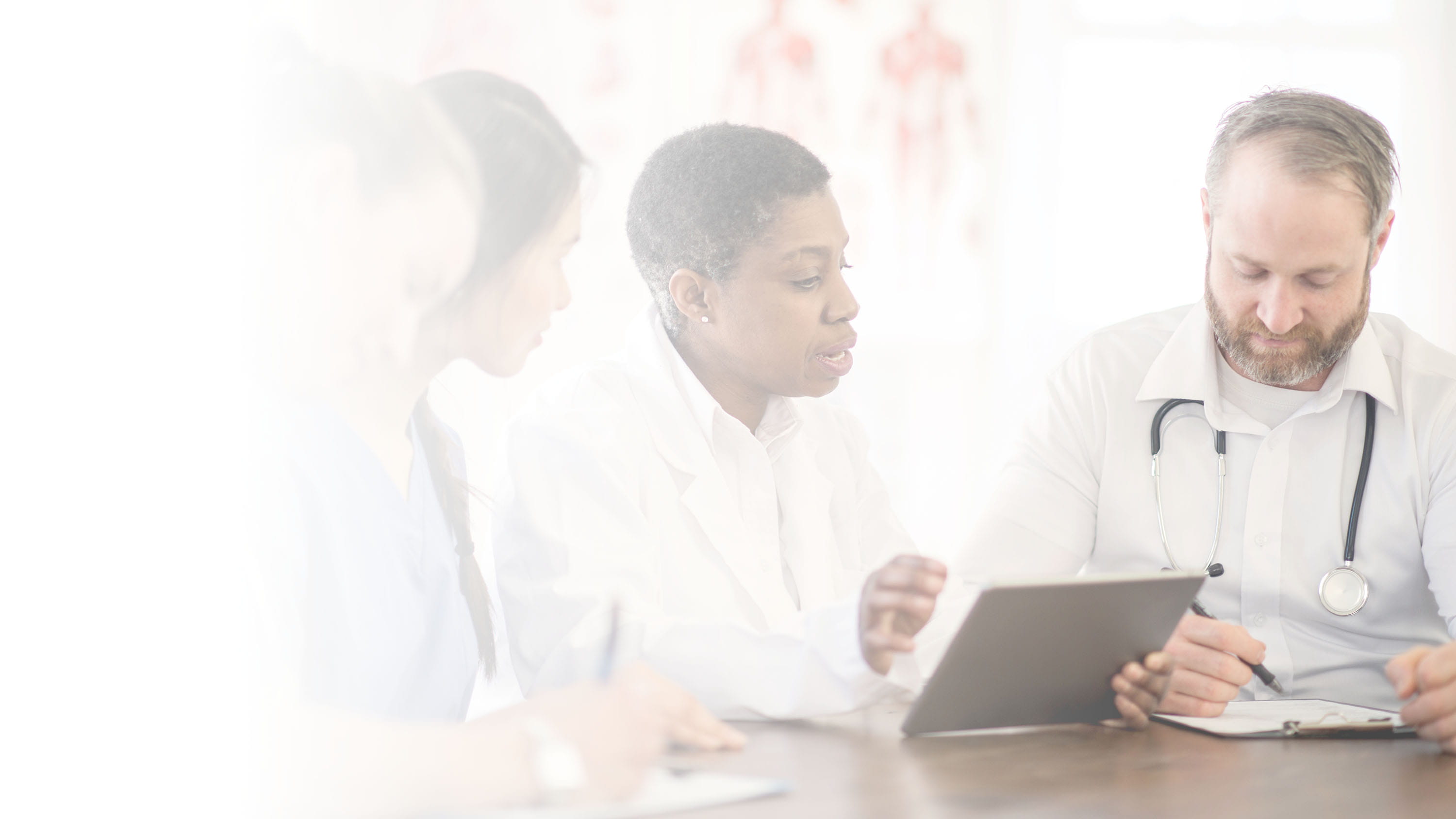 Healthcare workers using tablets-hero with gradient overlay