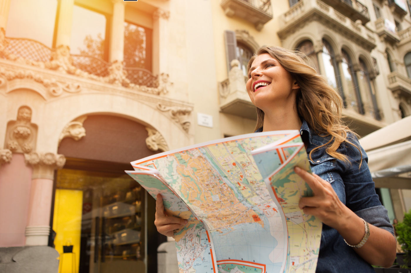 A woman using a map to navigate in a city.