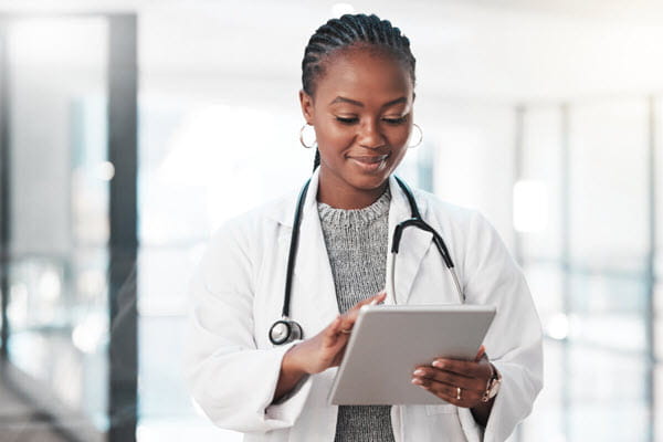 A young doctor working on a tablet.