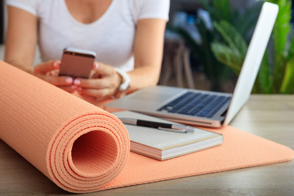 Woman and an exercise mat in an office