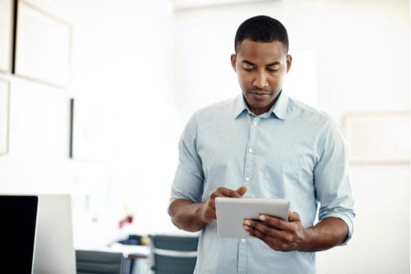 A young designer working on a digital tablet in an office