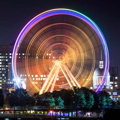 A carousel with purple and yellow glowing lights