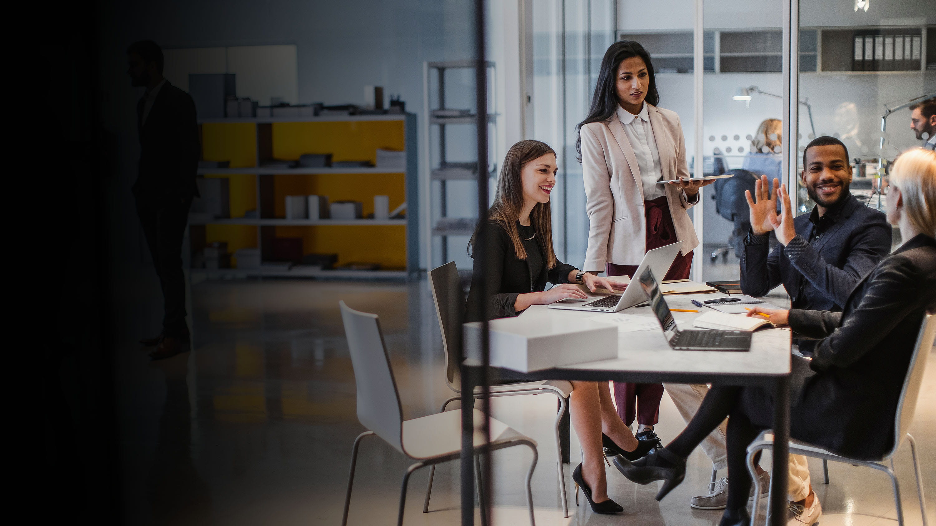 A group of colleagues in a lively discussion in a conference room.