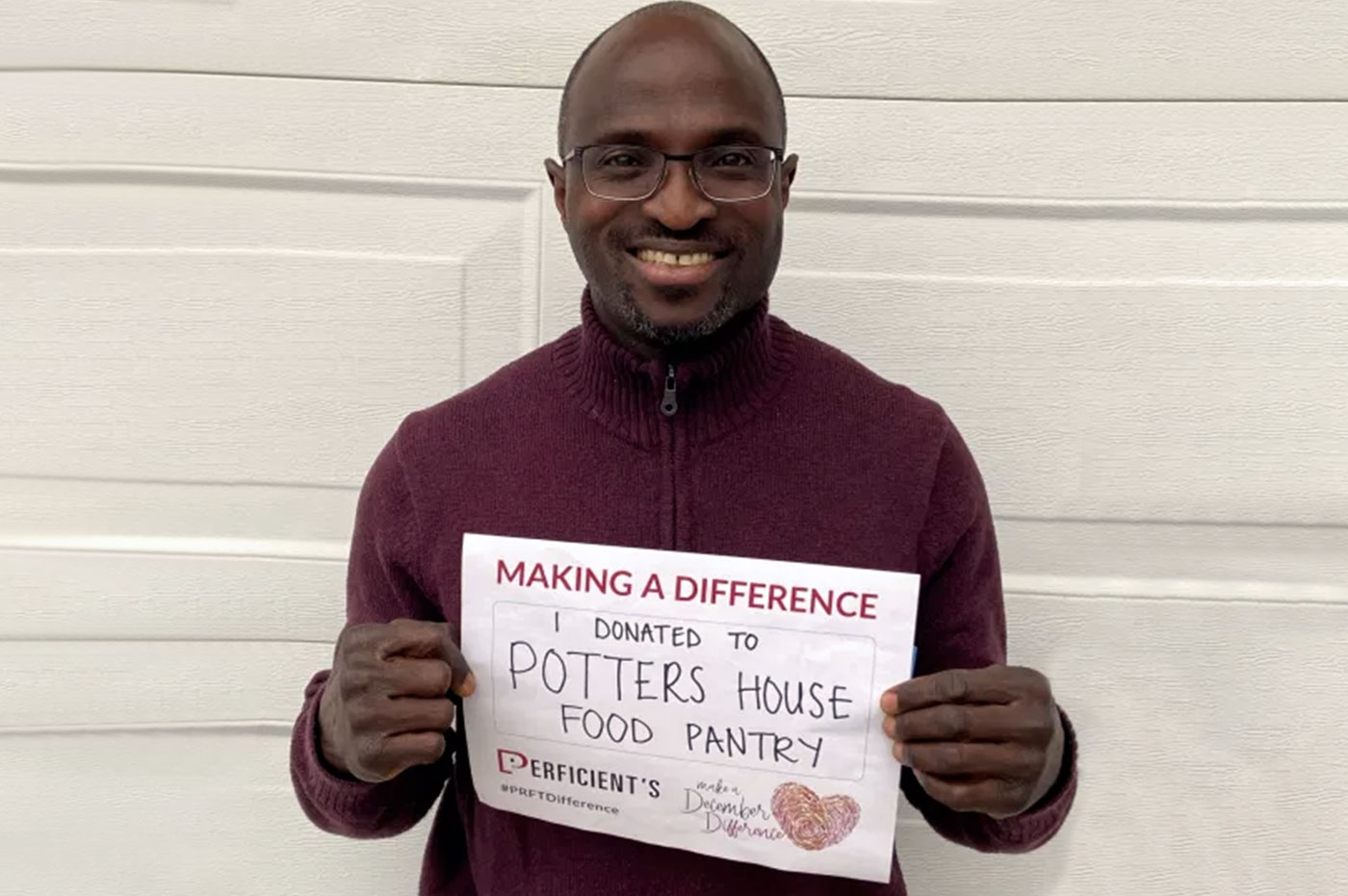 A colleagued holding a MADD sign for Potter's House Food Pantry.