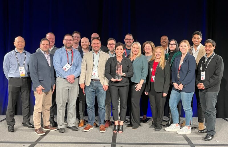 Perficient's Adobe team holding their 2023 Digital Experience Emerging Partner of the Year award.