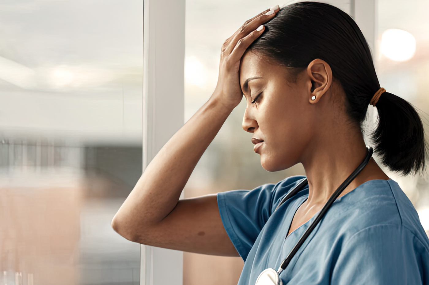 A nurse who looks to be frustrated or not feeling well.