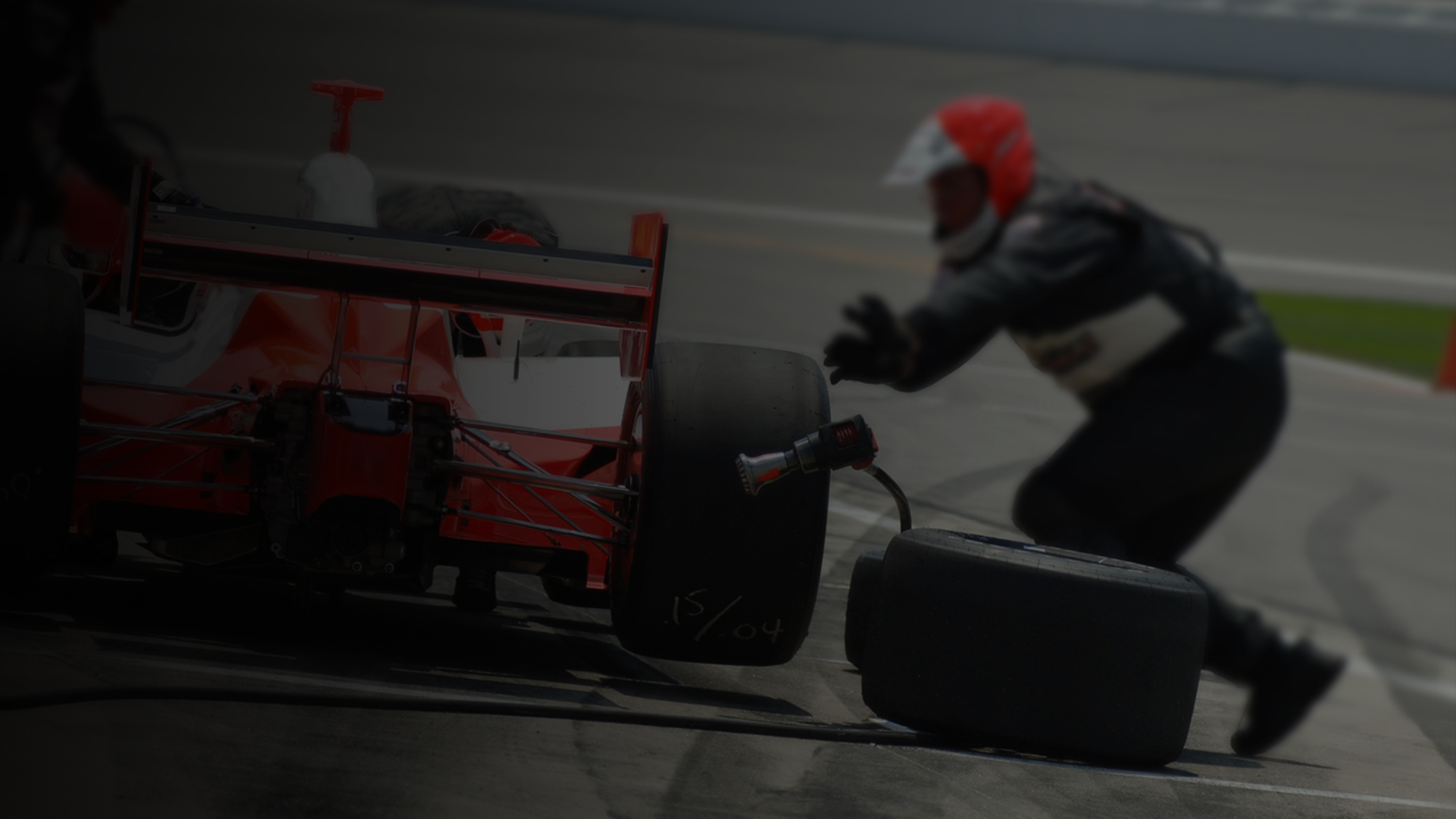 A pit crew working on a race car.