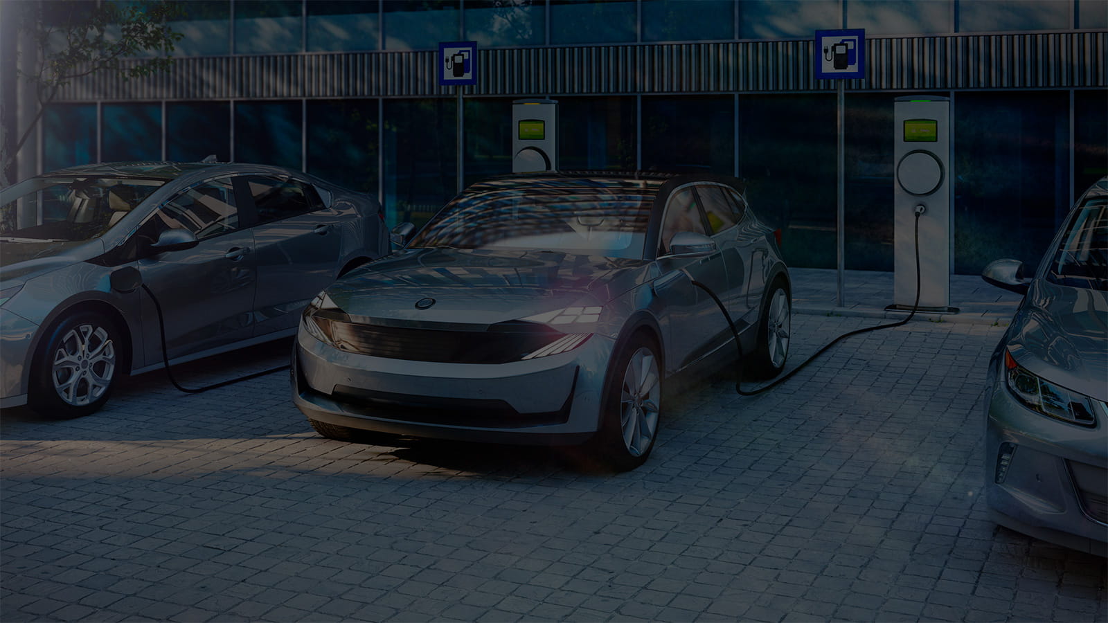 Three electric vehicles charging at a station