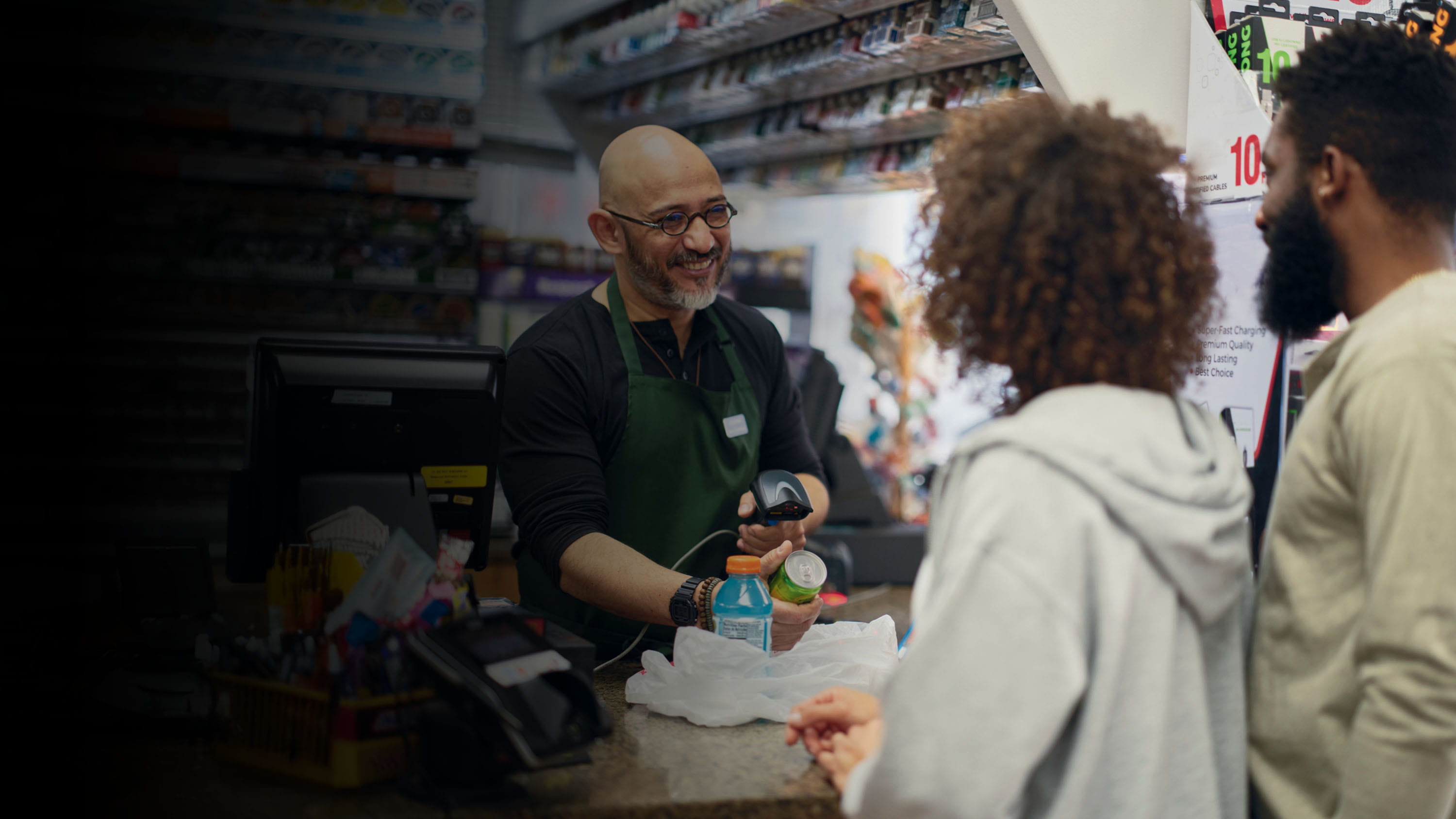 Customers checking out at a convenience store.
