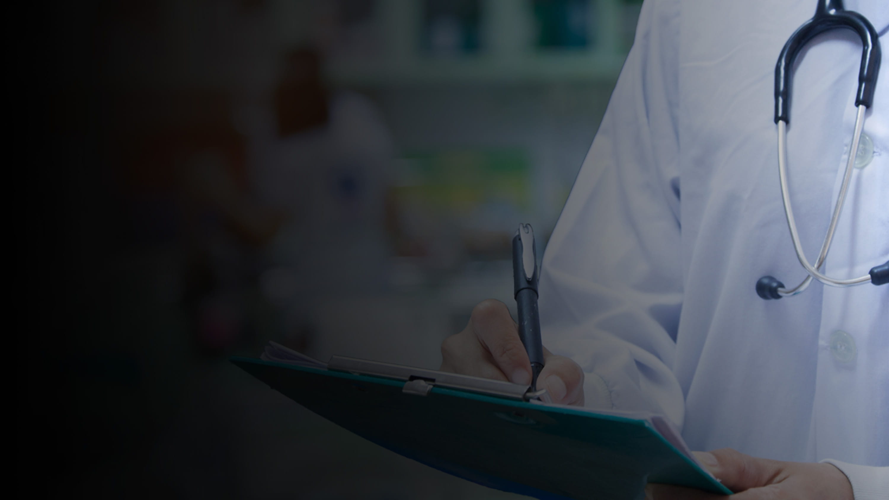 Healthcare workers writing on charts.