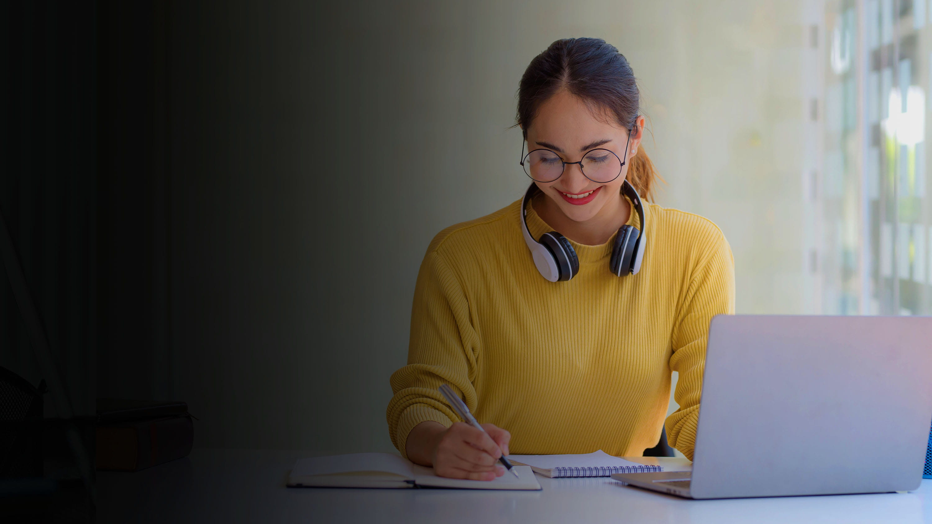 Woman at desk with a laptop