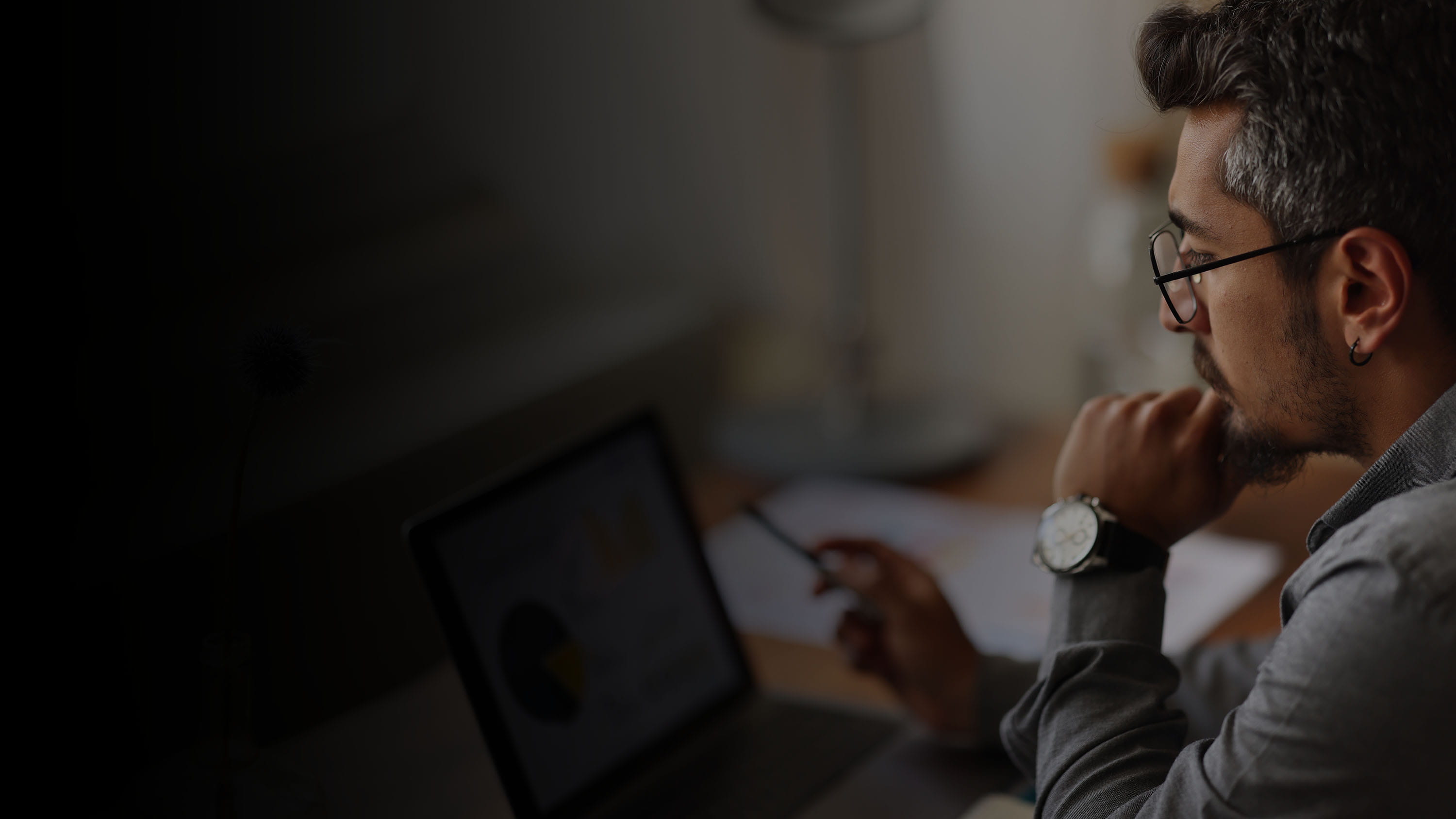 Man looking at a computer screen with charts on it