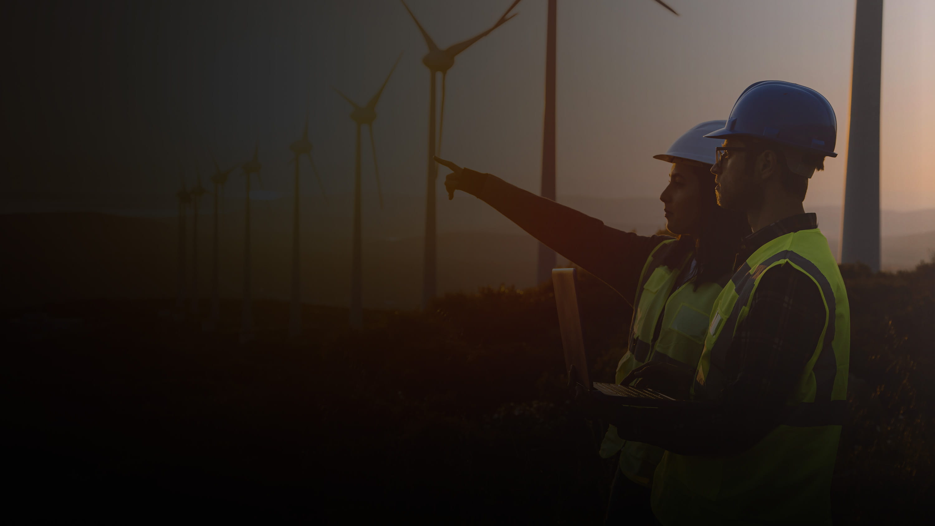 Two workers at a windmill farm