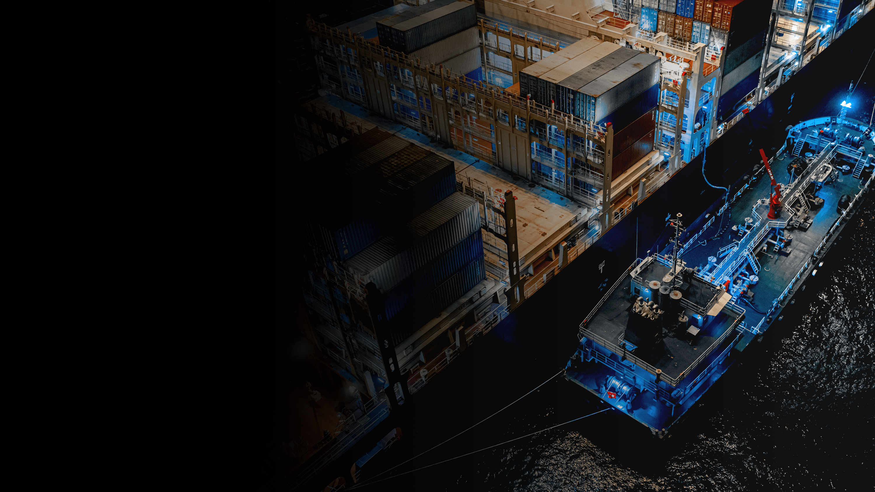 A shipping container docked at a shipyard.