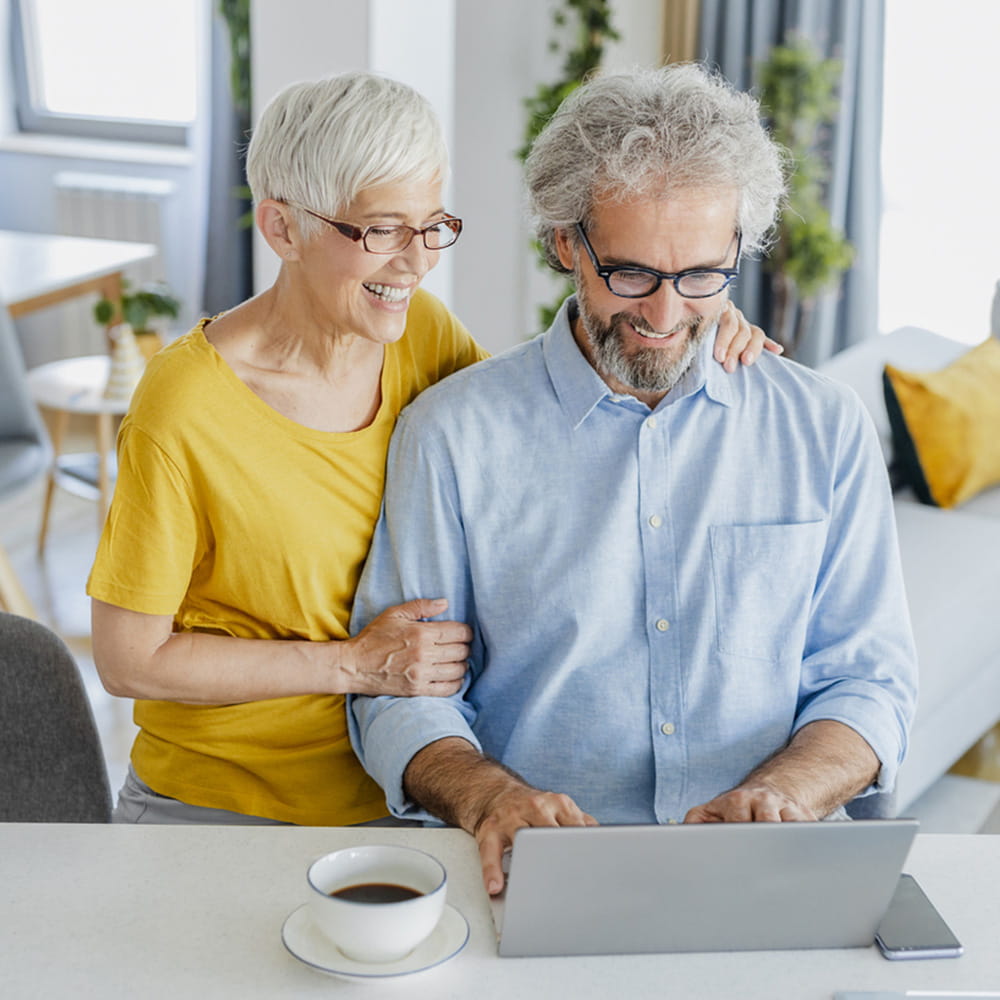 Older couple sitting in front of a computer