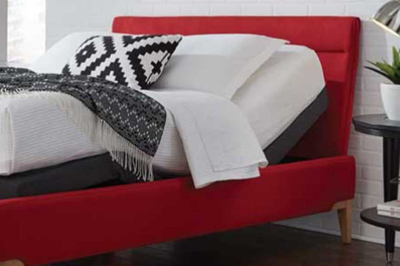 Nicely Made Bed Sitting on Adjustable Bed Frame