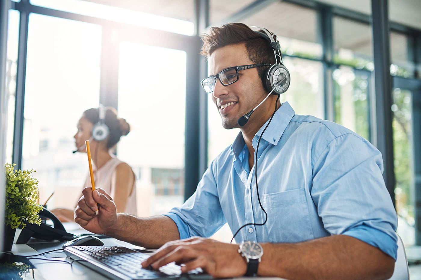 Business man wearing a headset in an office.