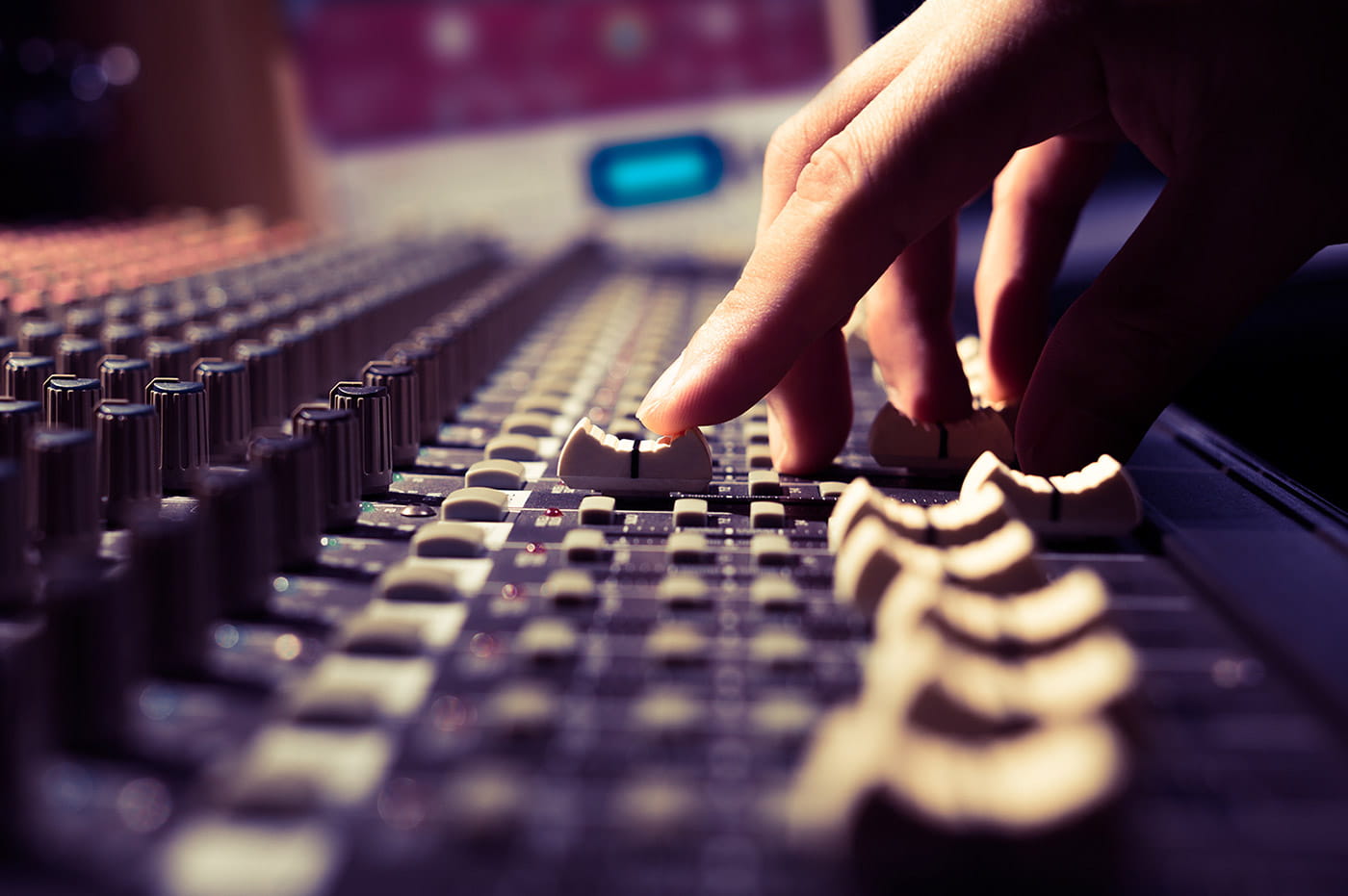 Hand working on sound effects board.