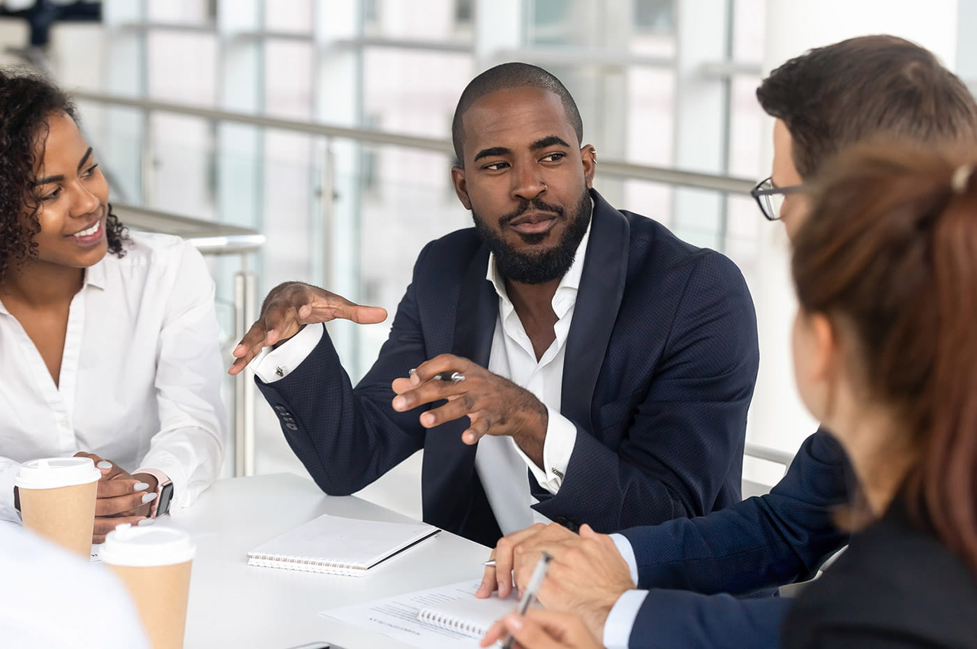 Business people sitting around a table talking.