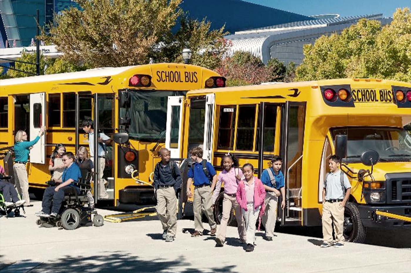 Children getting off of school busses.
