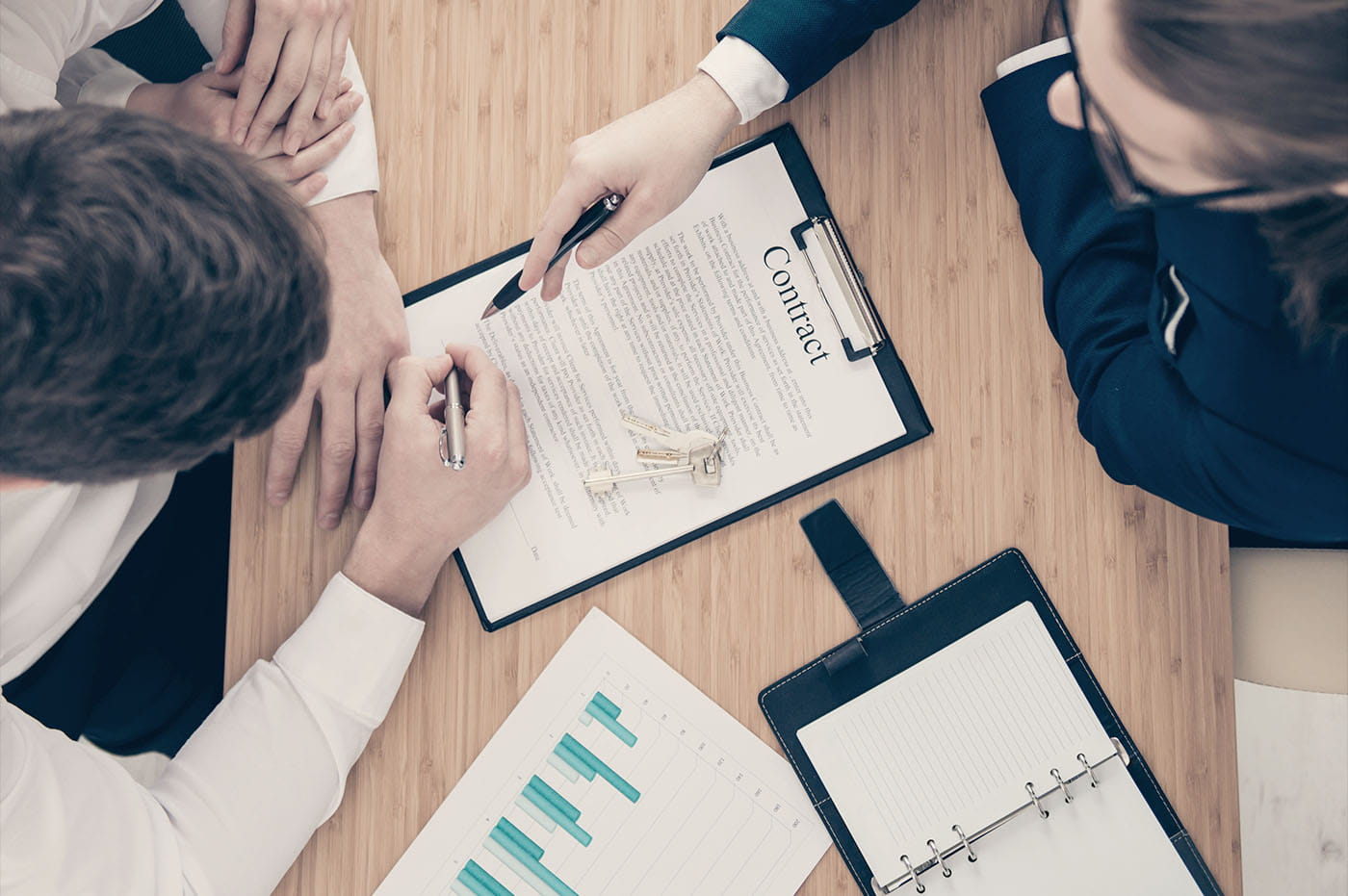 People signing a contract