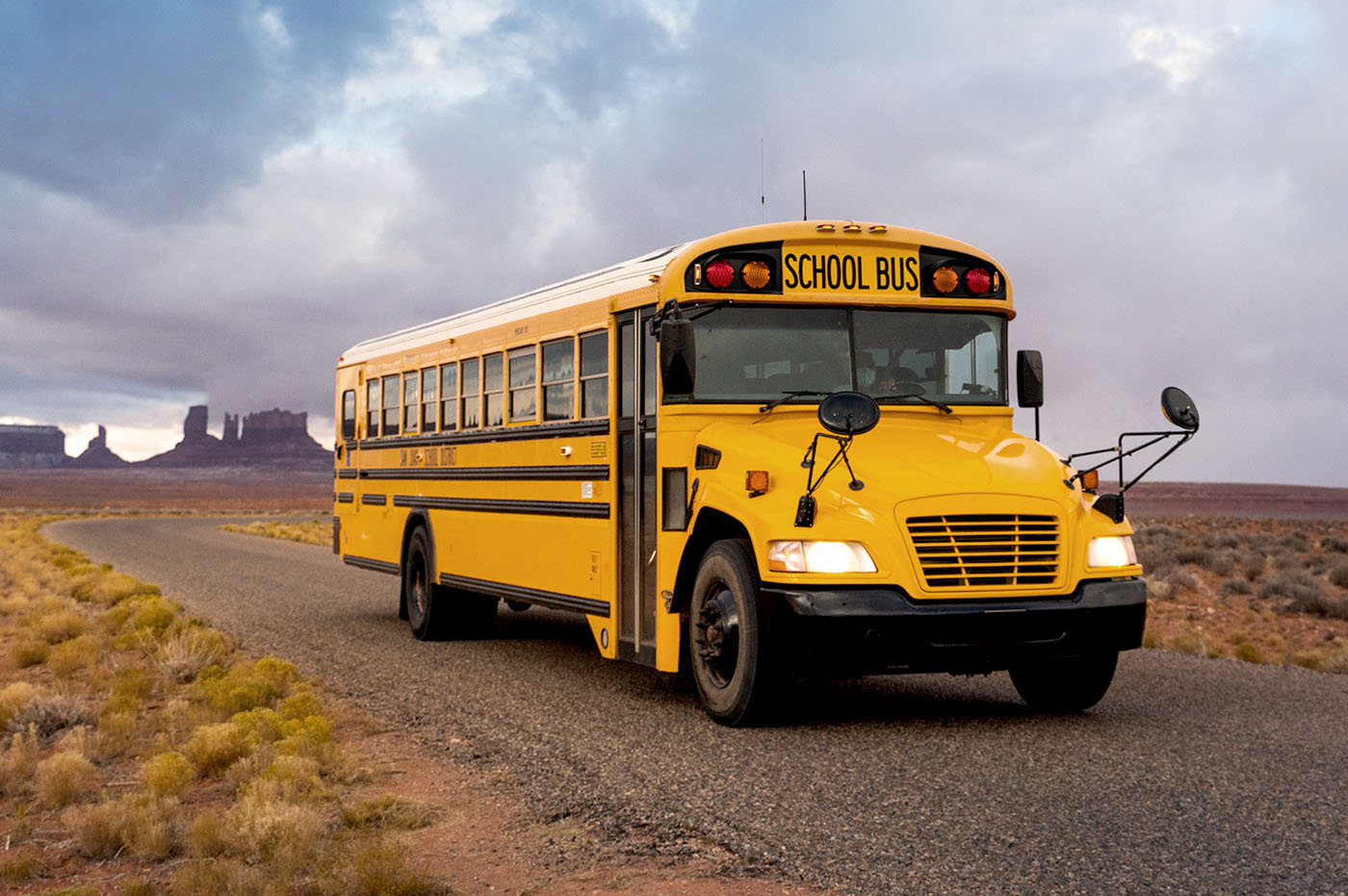 School bus driving on road