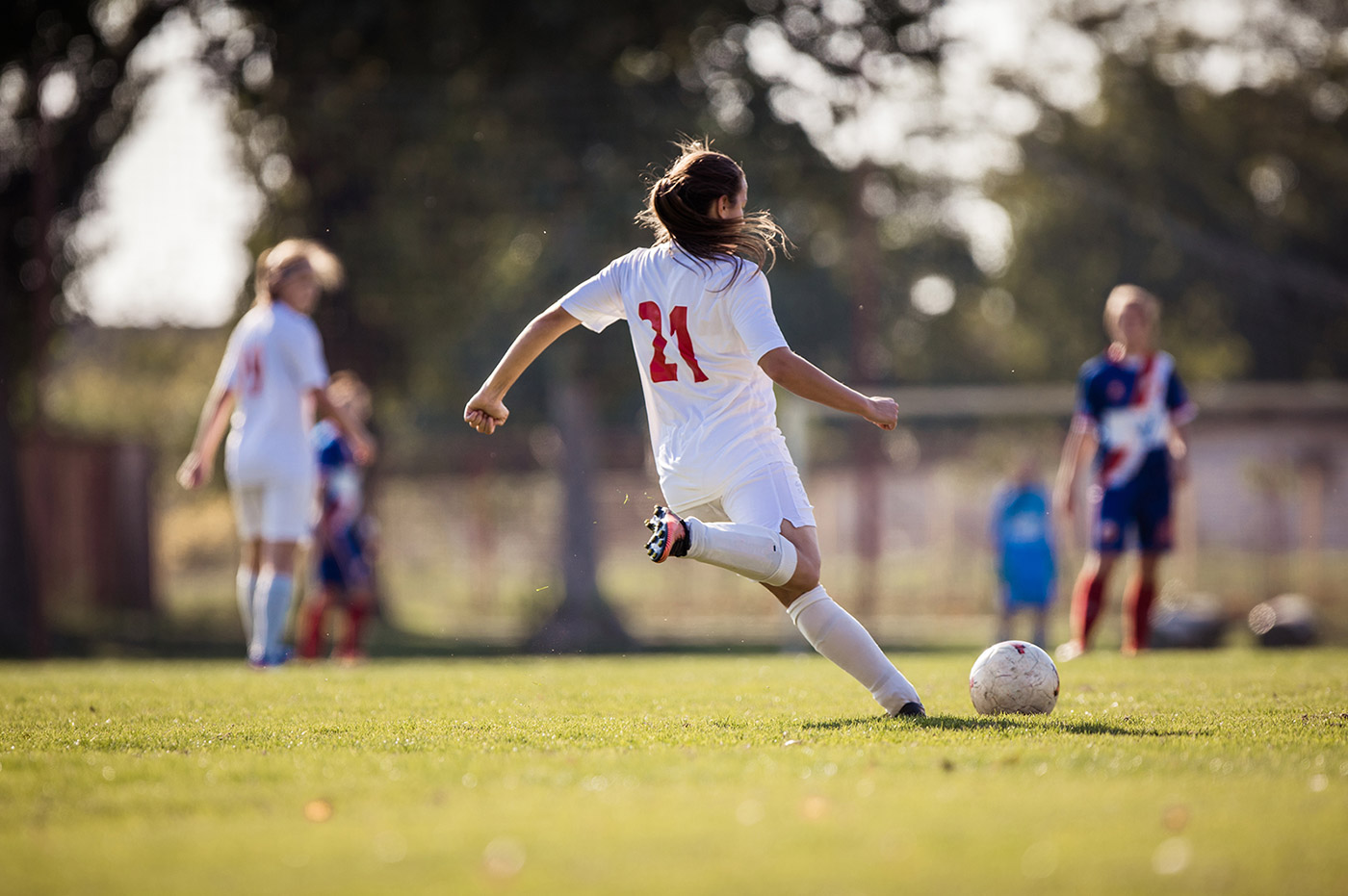 Young girls playing soccer.