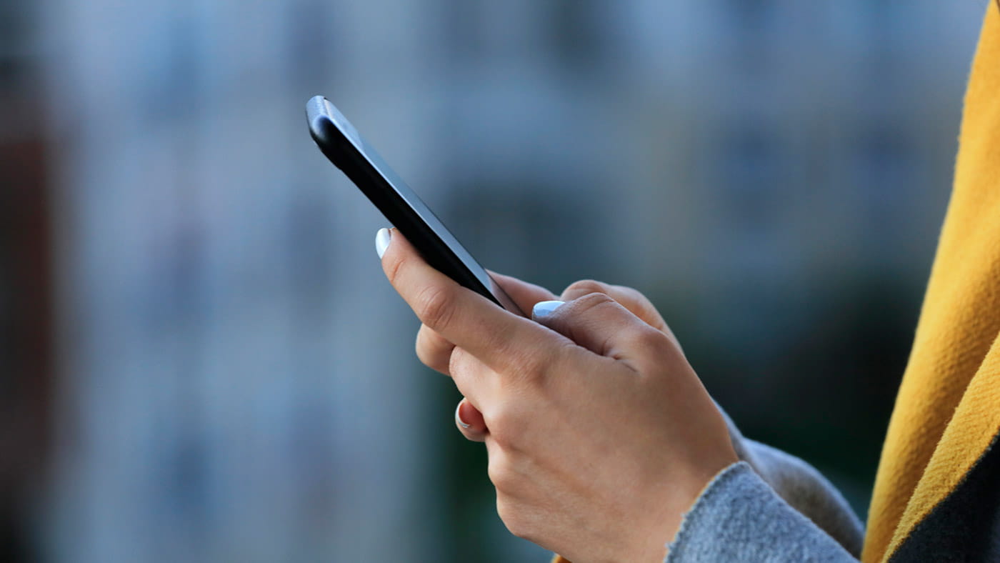 Person texting on a cell phone.