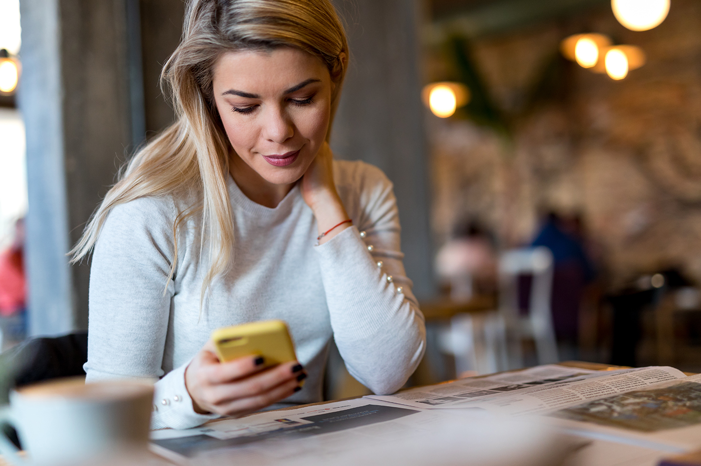 Woman scrolling on cell phone.