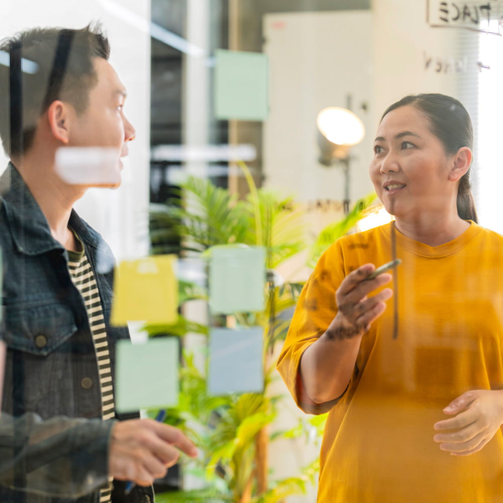 Two colleagues brainstorming and strategizing.