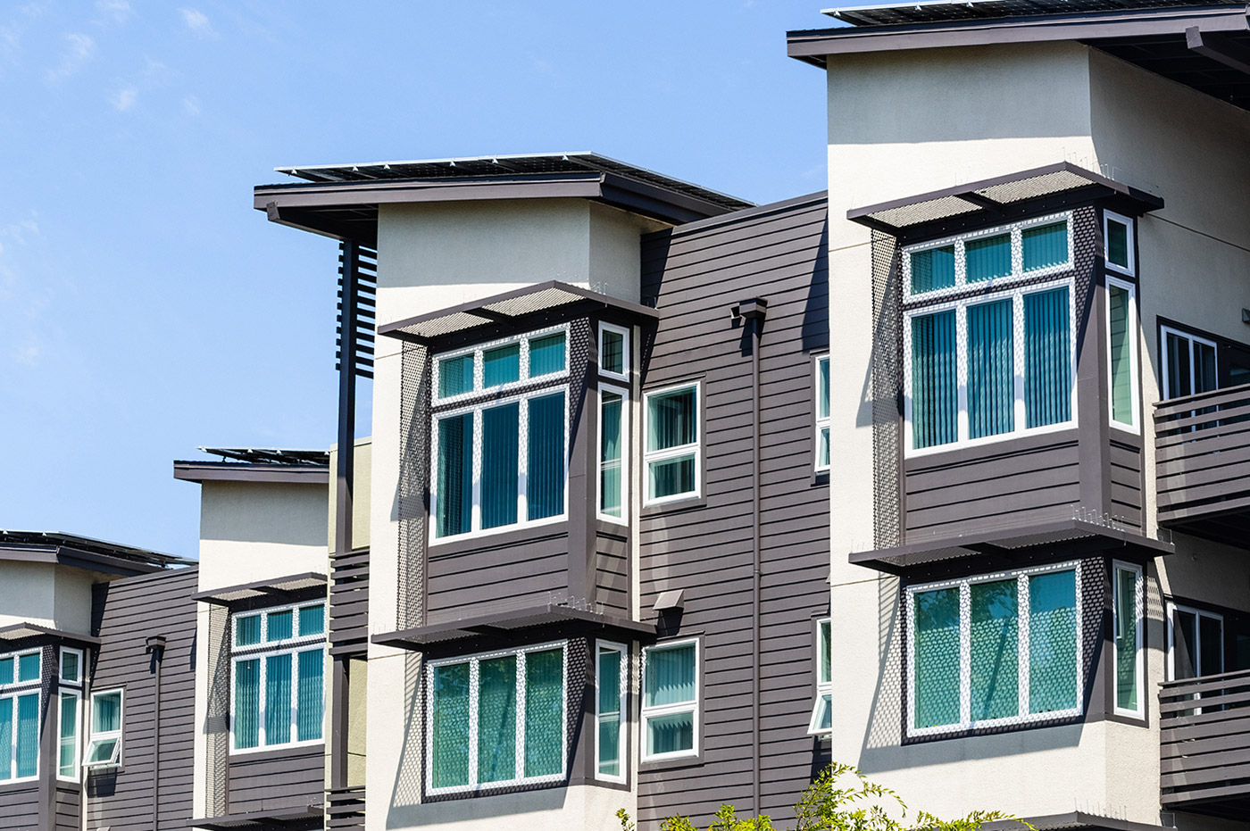 A row of grey and white apartment buildings.