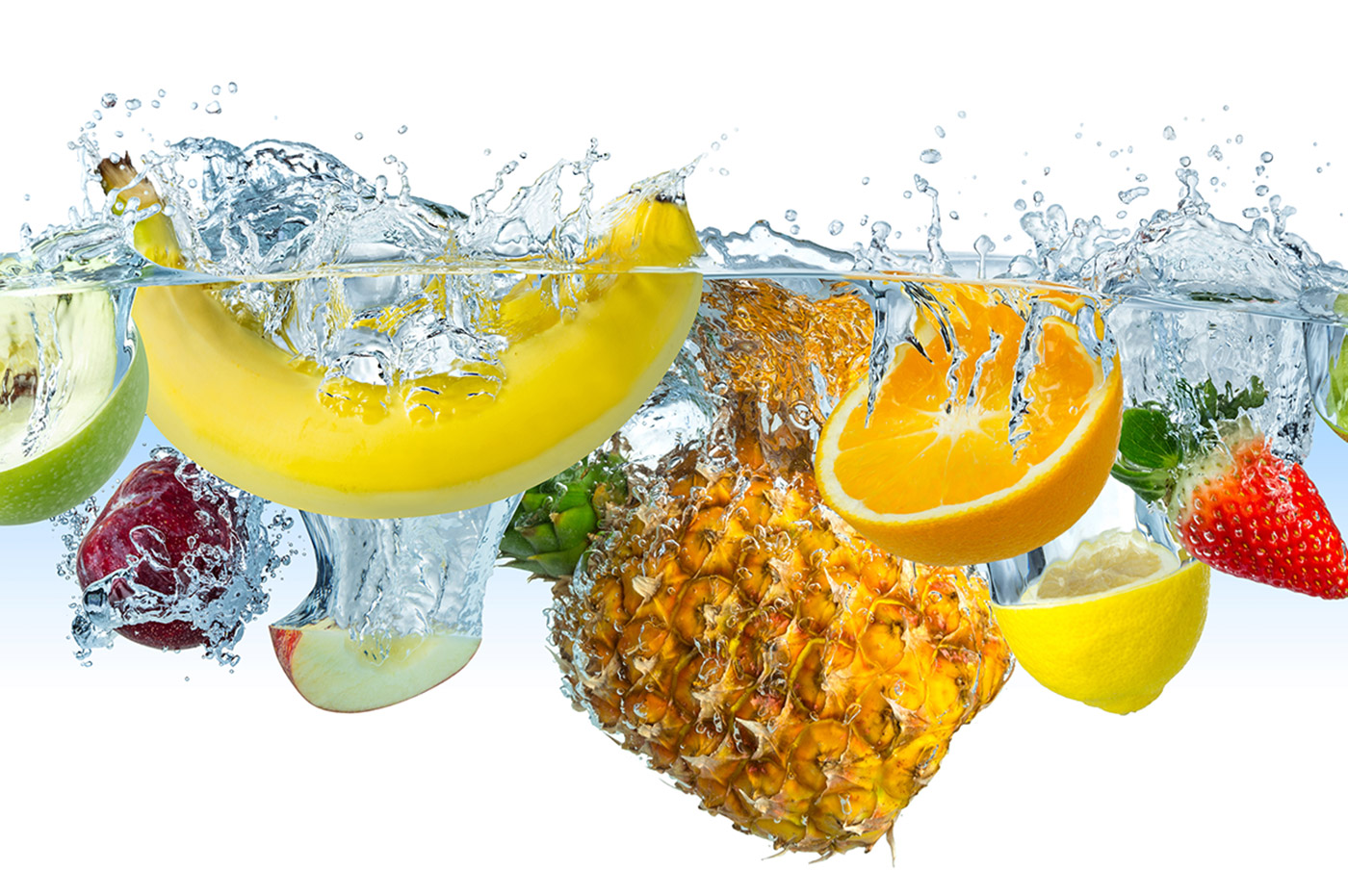 Various fruits splashing into a body of water.