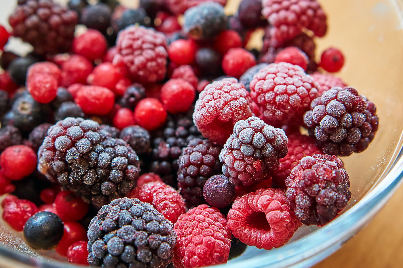 Bowl of mixed berries with sugar sprinkled on them.