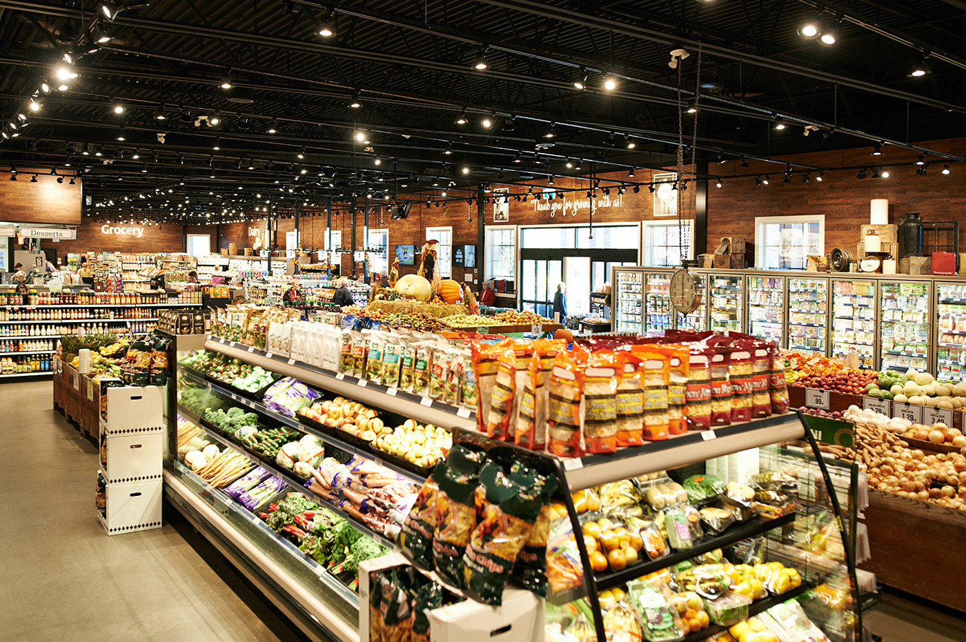 An image overlooking most of a grocery store, with part of the product center in the front.