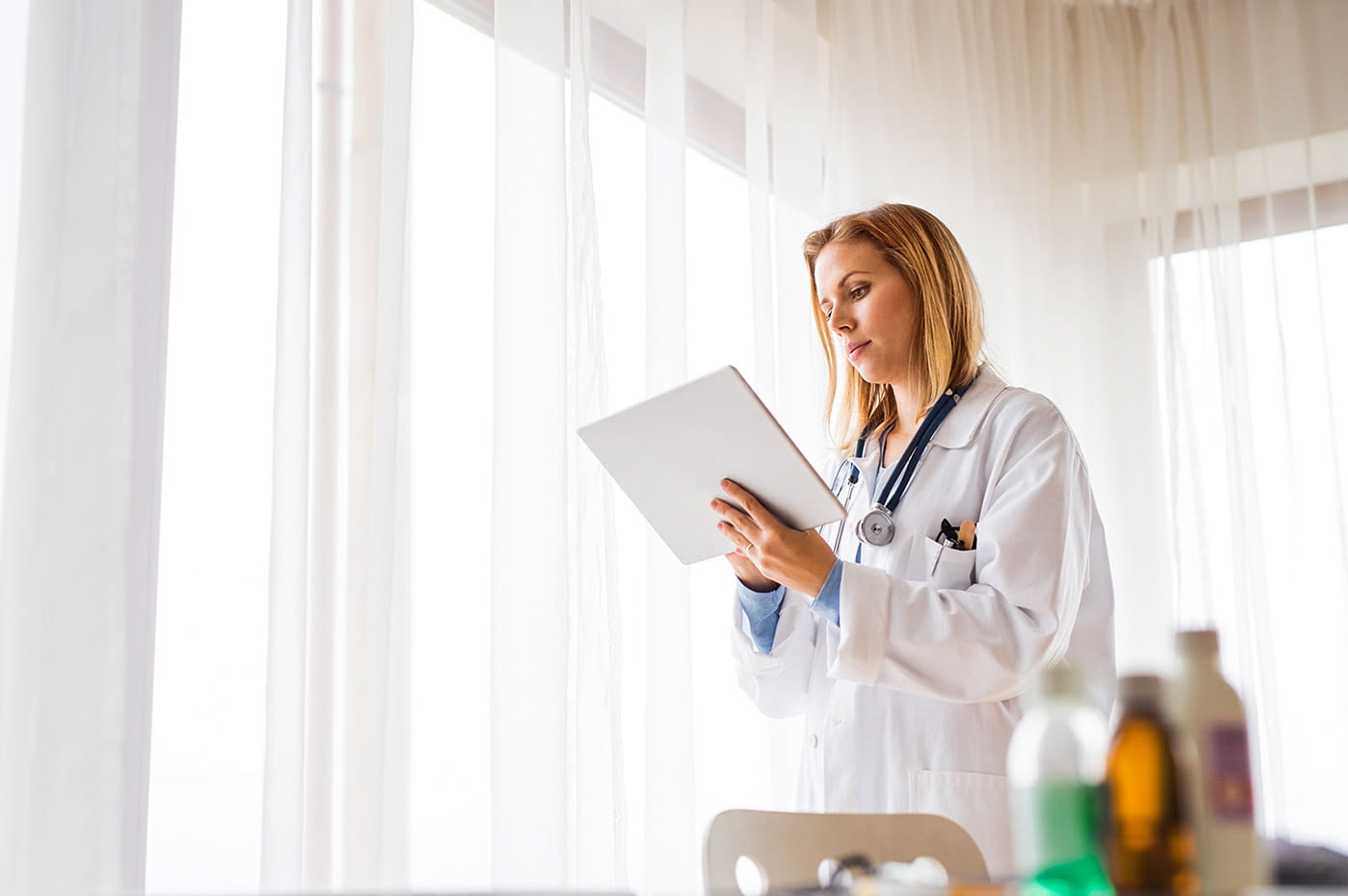 A female doctor working on a tablet.