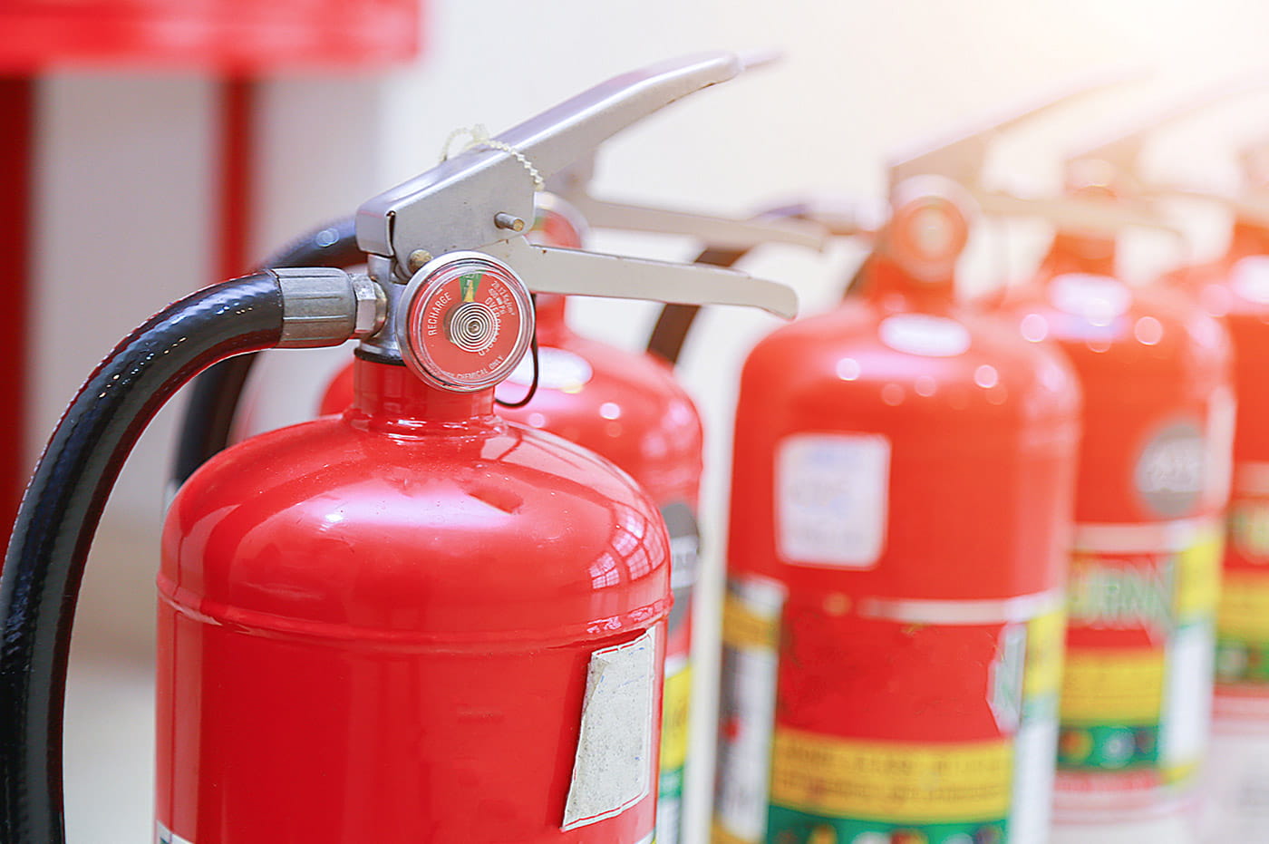 A line of fire extinguisher cannisters.