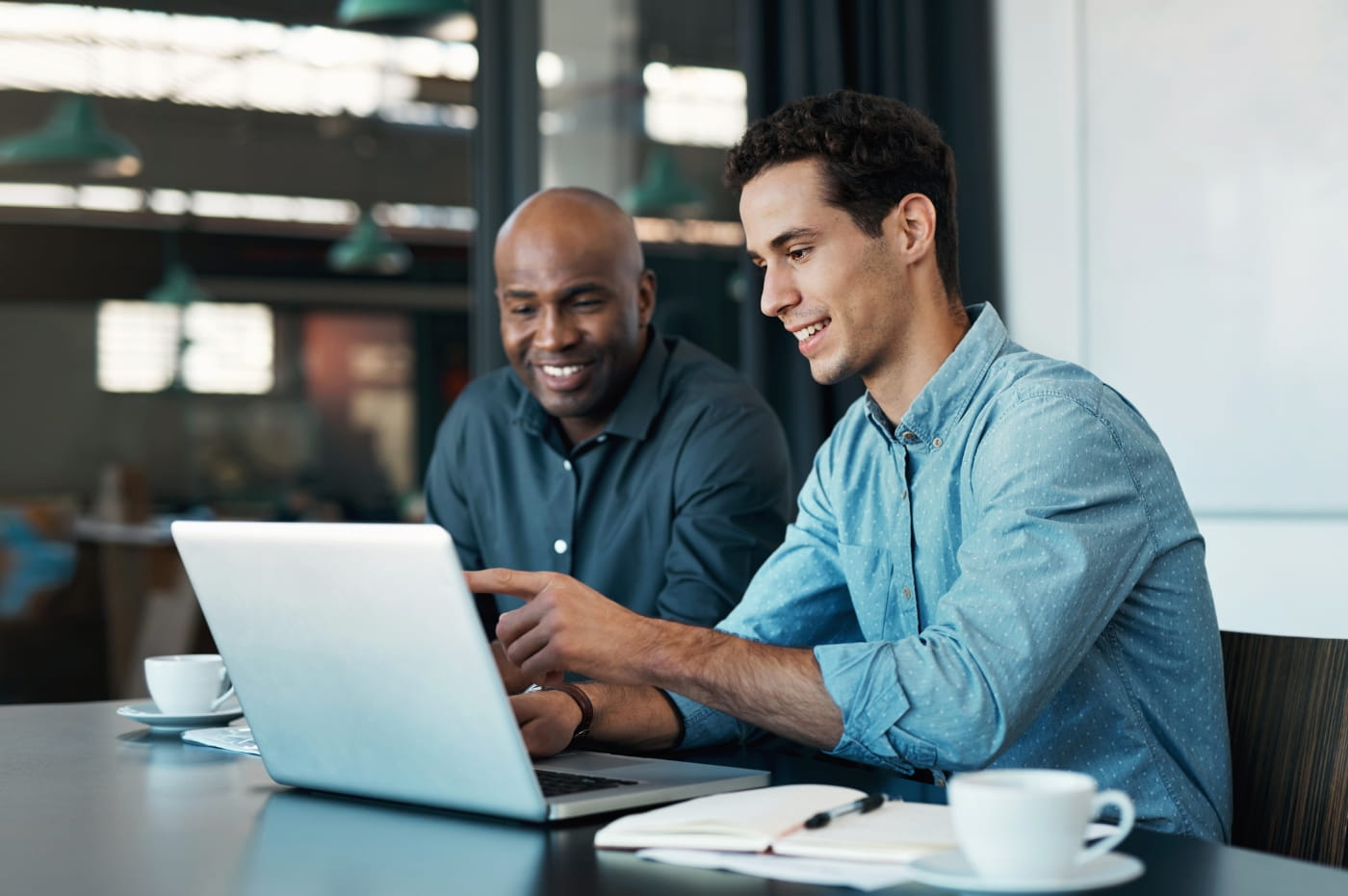 Two Businessmen looking at a laptop. 