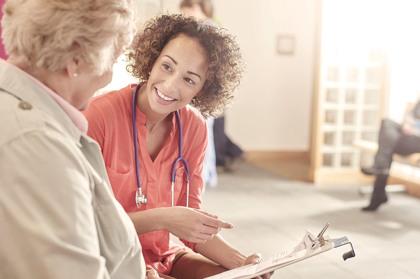 A female heathcare worker reviewing information with a patient.