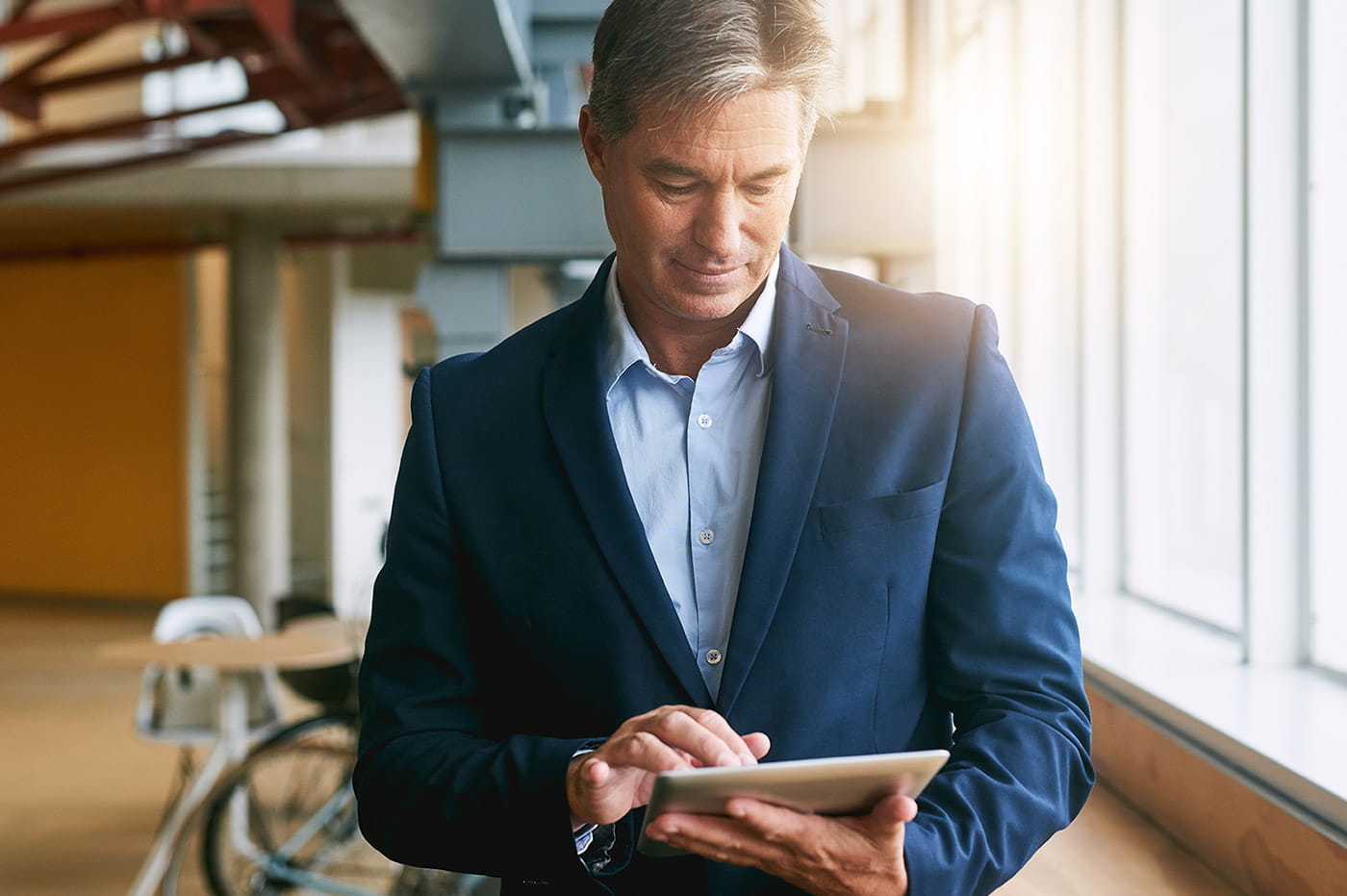 A business man working on an iPad.